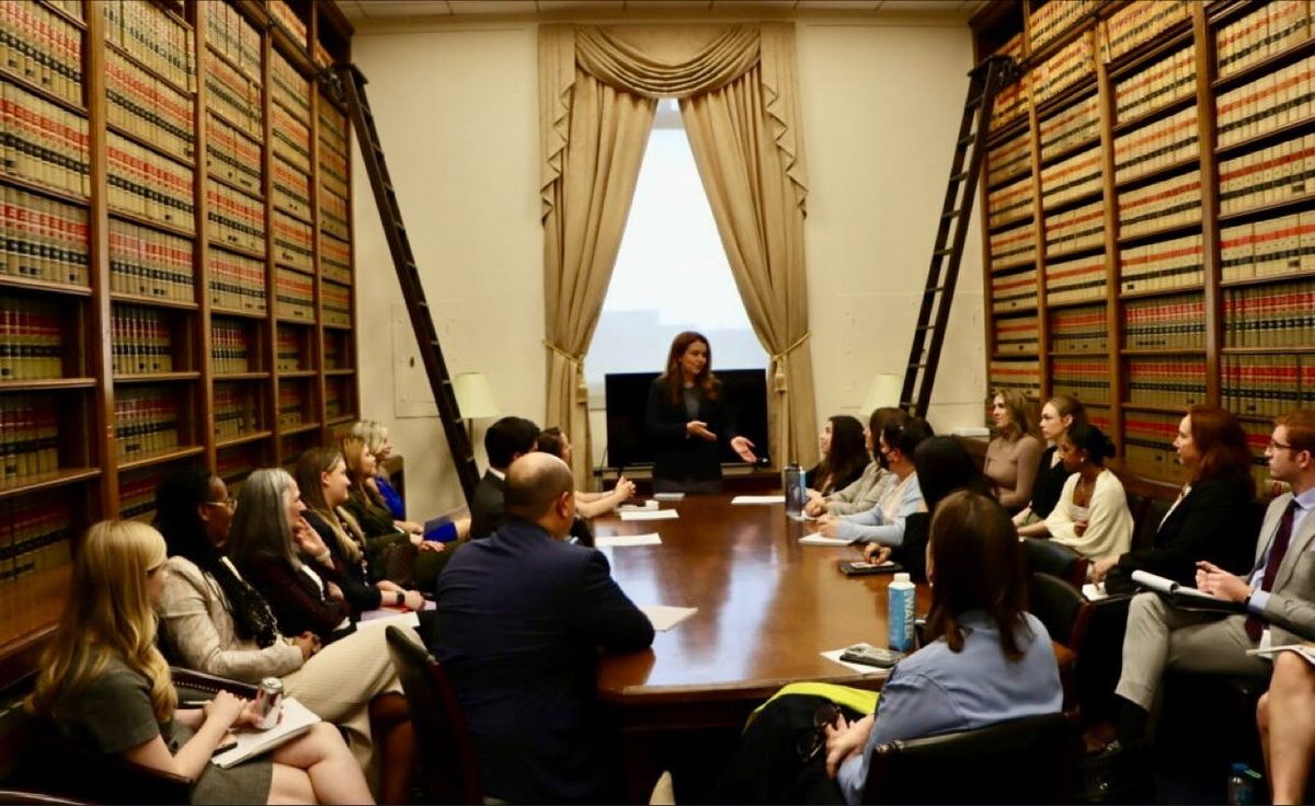 A meeting in a wood-paneled library